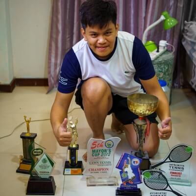 Coach Geo trophies on the floor during his competitive years