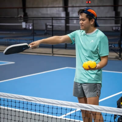 Cebu Pickleball Coach pointing where to stand