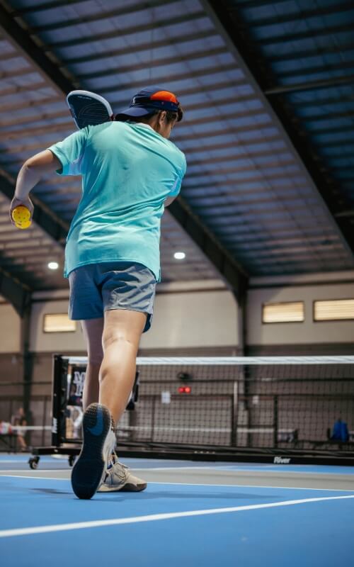 Coach Geo showing the correct form for a powerful forehand drive